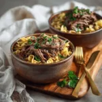 Slow cooker beef and noodles in a ceramic bowl