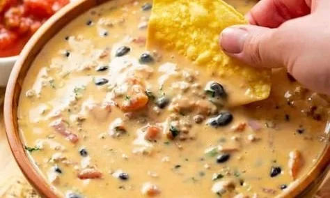Delicious Cowboy Queso served in a bowl with tortilla chips