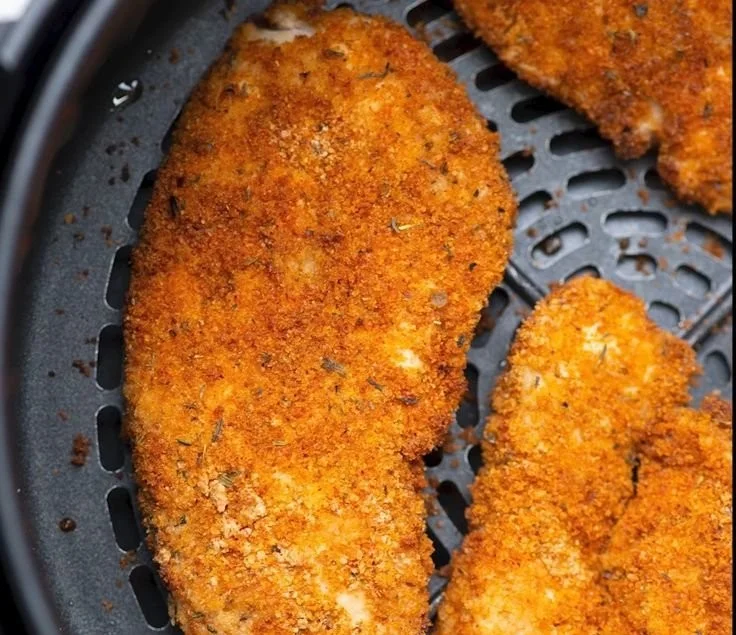 Juicy air fryer boneless chicken breast garnished with herbs and spices