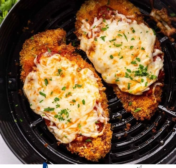 Crispy Air Fryer Chicken Parmesan served with marinara sauce and herbs
