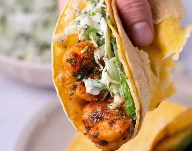 Cilantro Lime Shrimp Tacos topped with creamy slaw on a plate