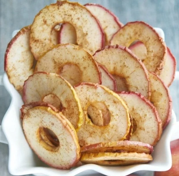 Homemade apple cinnamon chips fresh from the oven, a healthy snack option.