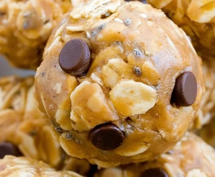 A plate of homemade no-bake energy balls made with oats, nuts, and honey.
