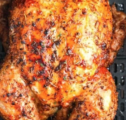 Whole roasted chicken cooked in an air fryer for a quick and delicious meal