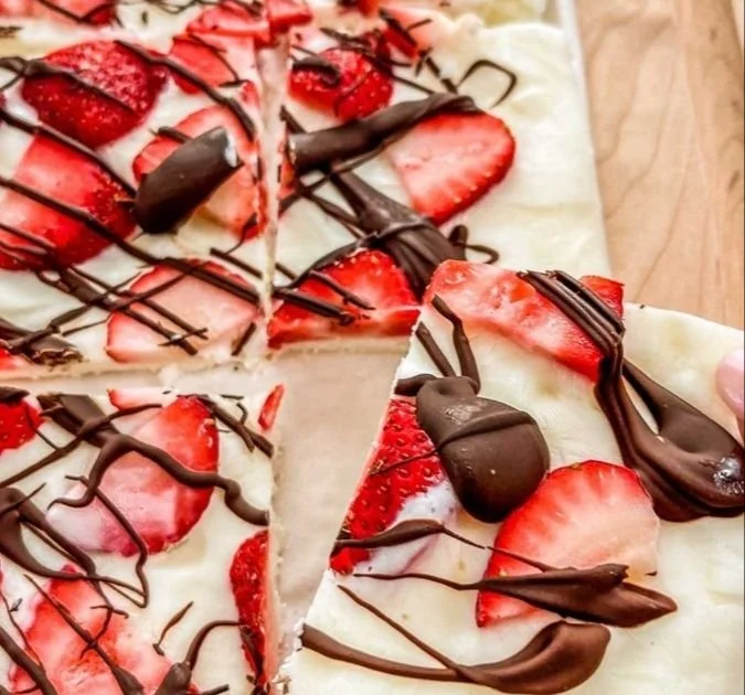 Homemade strawberry yogurt bark topped with fresh strawberries and nuts