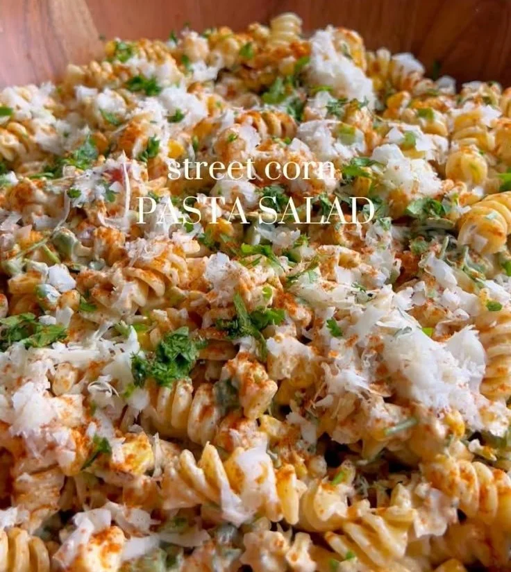 A vibrant bowl of Street Corn Pasta Salad with fresh vegetables and herbs.