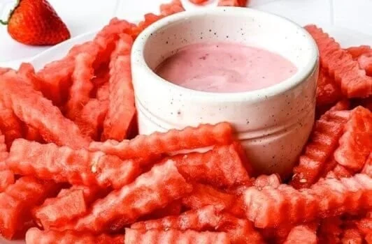 Plate of TikTok watermelon fries with strawberry yogurt dip for a healthy snack