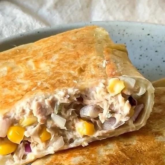 Tuna melt wrap with tender tuna and melted cheese in a tortilla