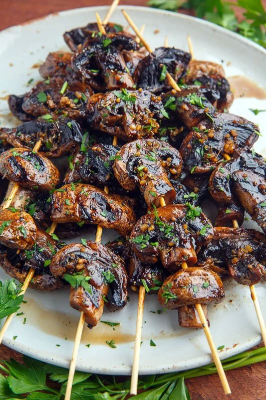 Balsamic garlic grilled mushroom skewers on a grill, ready to serve.