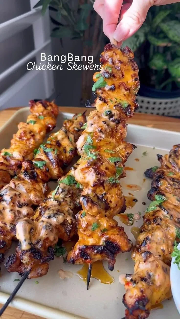 Delicious Bang Bang Chicken Skewers garnished and ready for serving.