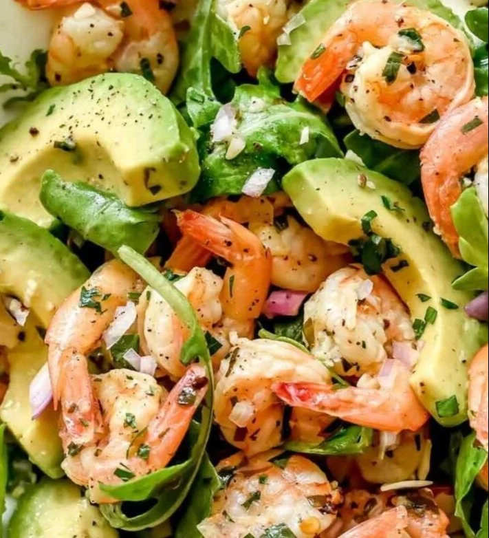 Citrus shrimp salad with avocado and fresh ingredients served in a bowl