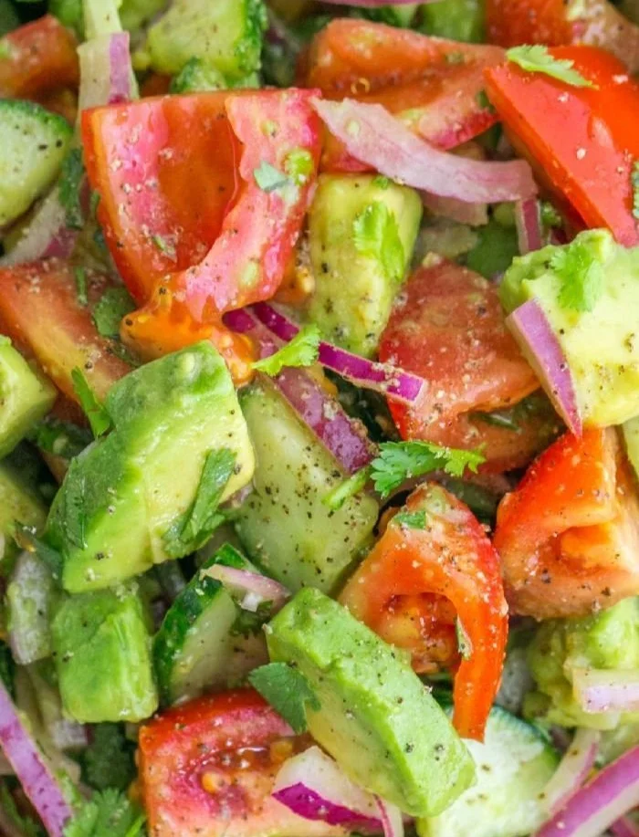 Cucumber tomato avocado salad with fresh ingredients and a colorful presentation.
