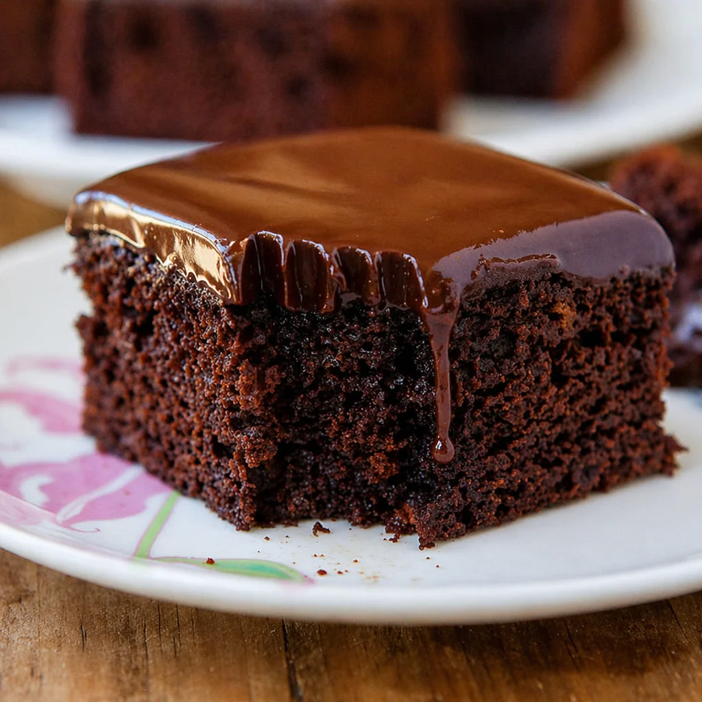 Moist chocolate cake with ganache frosting, topped with rich chocolate ganache.