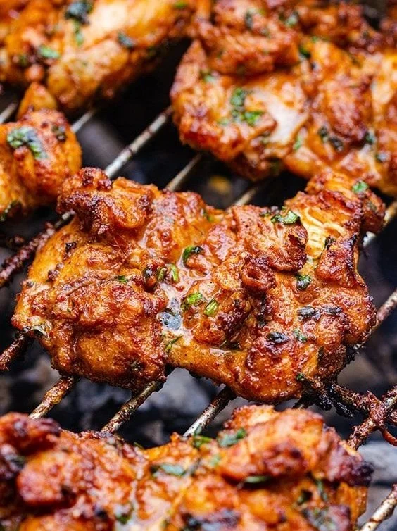 Delicious grilled boneless chicken thighs on a barbecue grill