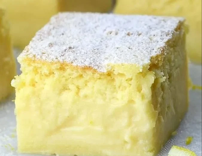 A delicious Lemon Custard Cake with a bright lemon glaze and creamy custard filling.