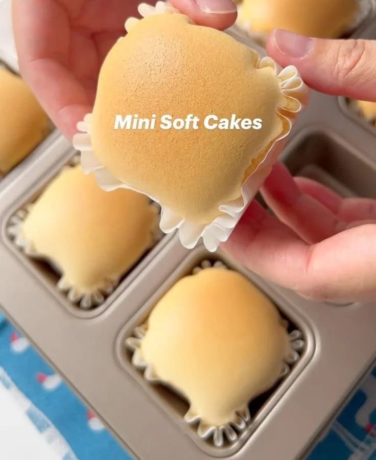 Mini soft cakes topped with cream and colorful sprinkles