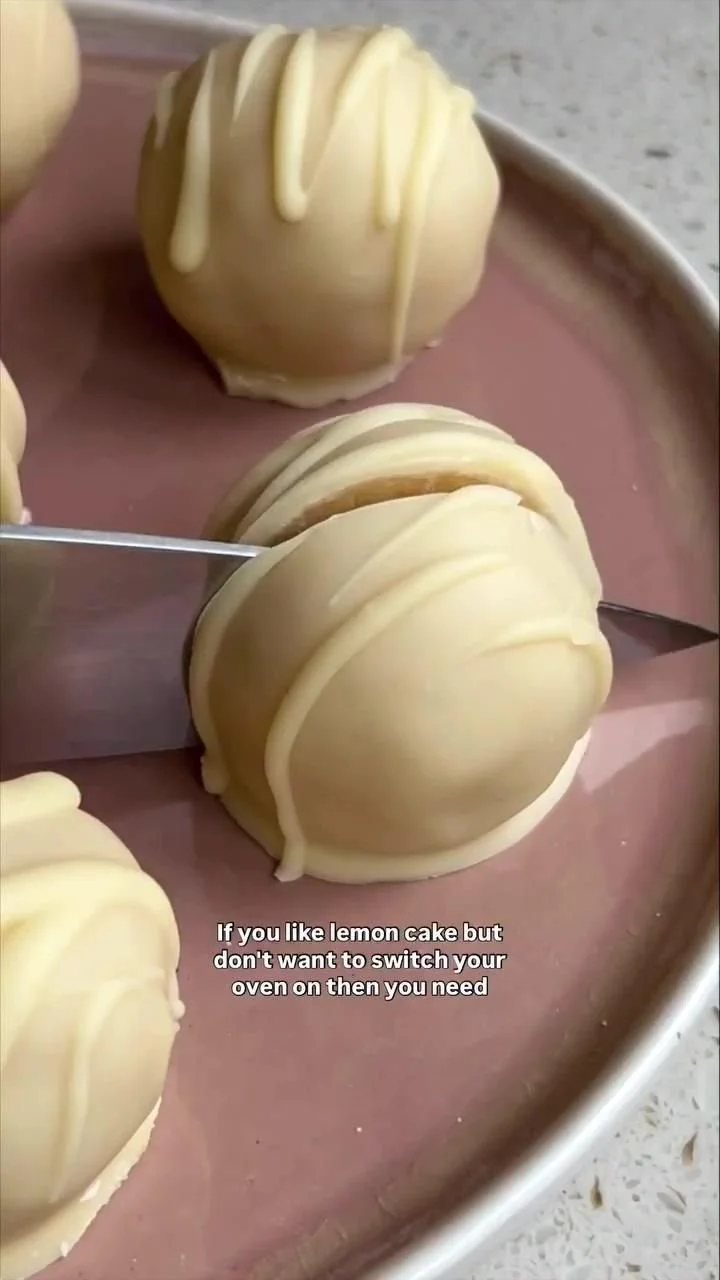 Delicious no-bake lemon truffles on a plate, showcasing their vibrant yellow color.