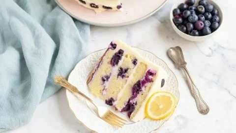 Delicious lemon blueberry cake topped with fresh blueberries and lemon zest