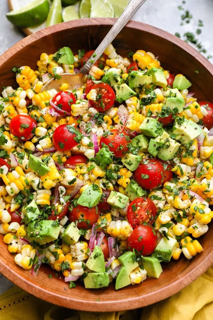 Summer corn salad with avocado and fresh vegetables served in a bowl