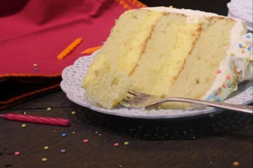 Perfectly baked vanilla birthday cake with creamy frosting and colorful sprinkles.