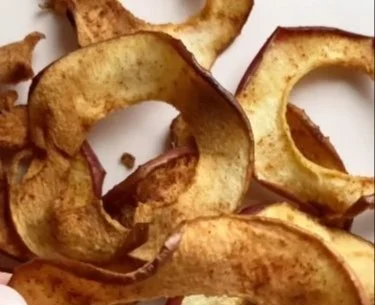Crispy air fryer apple chips served in a bowl, healthy snack alternative