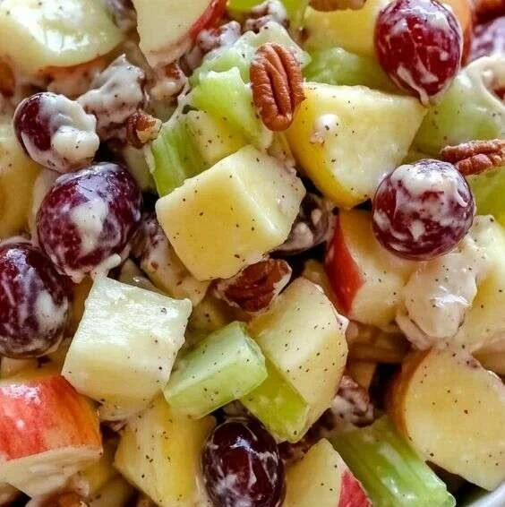 Fresh apple salad with nuts and dressing in a bowl