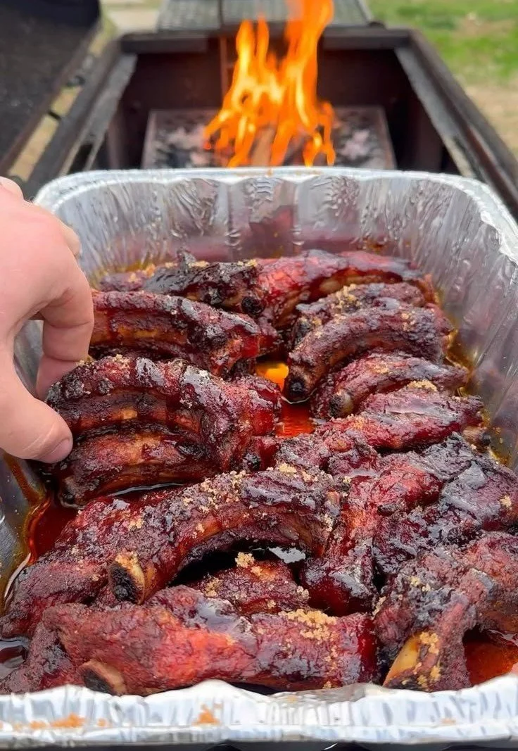 Deliciously grilled BBQ ribs served on a platter with sides