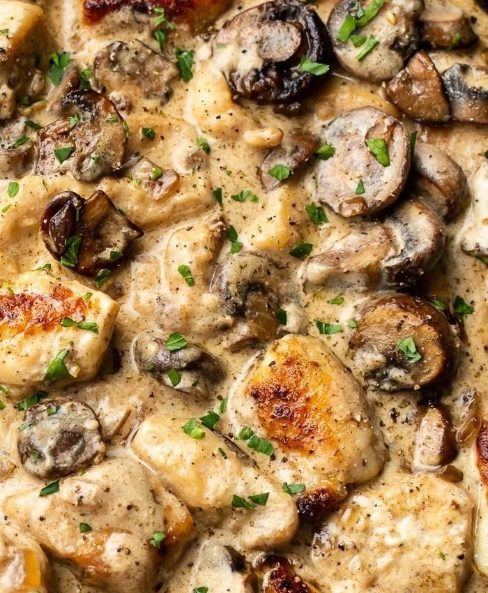 Creamy chicken stroganoff served with noodles and fresh herbs.