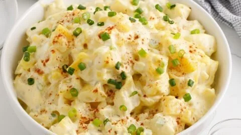 Creamy potato salad served in a bowl with fresh herbs and spices