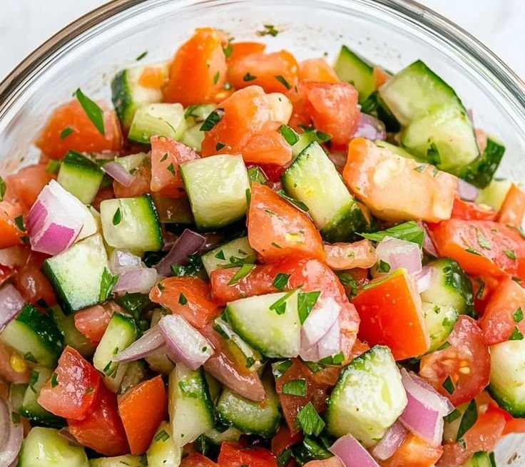 Fresh Italian Cucumber Salad with herbs and tomatoes in a bowl
