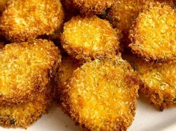 Crispy air fryer pickles served on a plate with dipping sauce