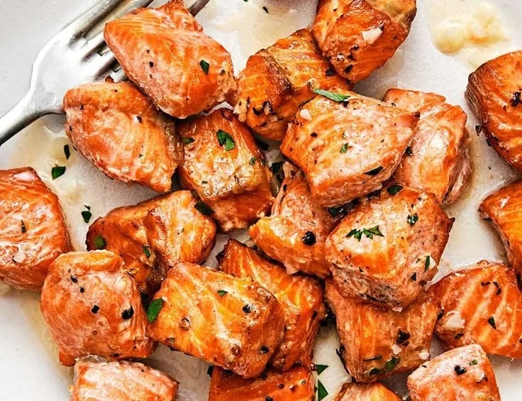 Crispy air fryer salmon bites served on a plate with dipping sauce
