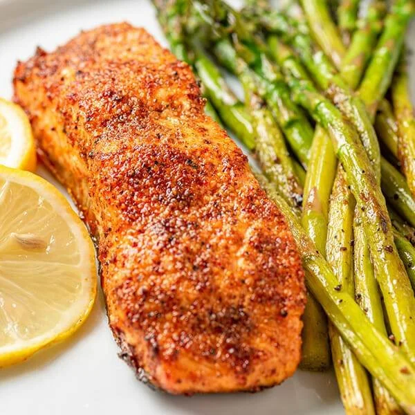 Delicious air fryer salmon served with lemon and herbs
