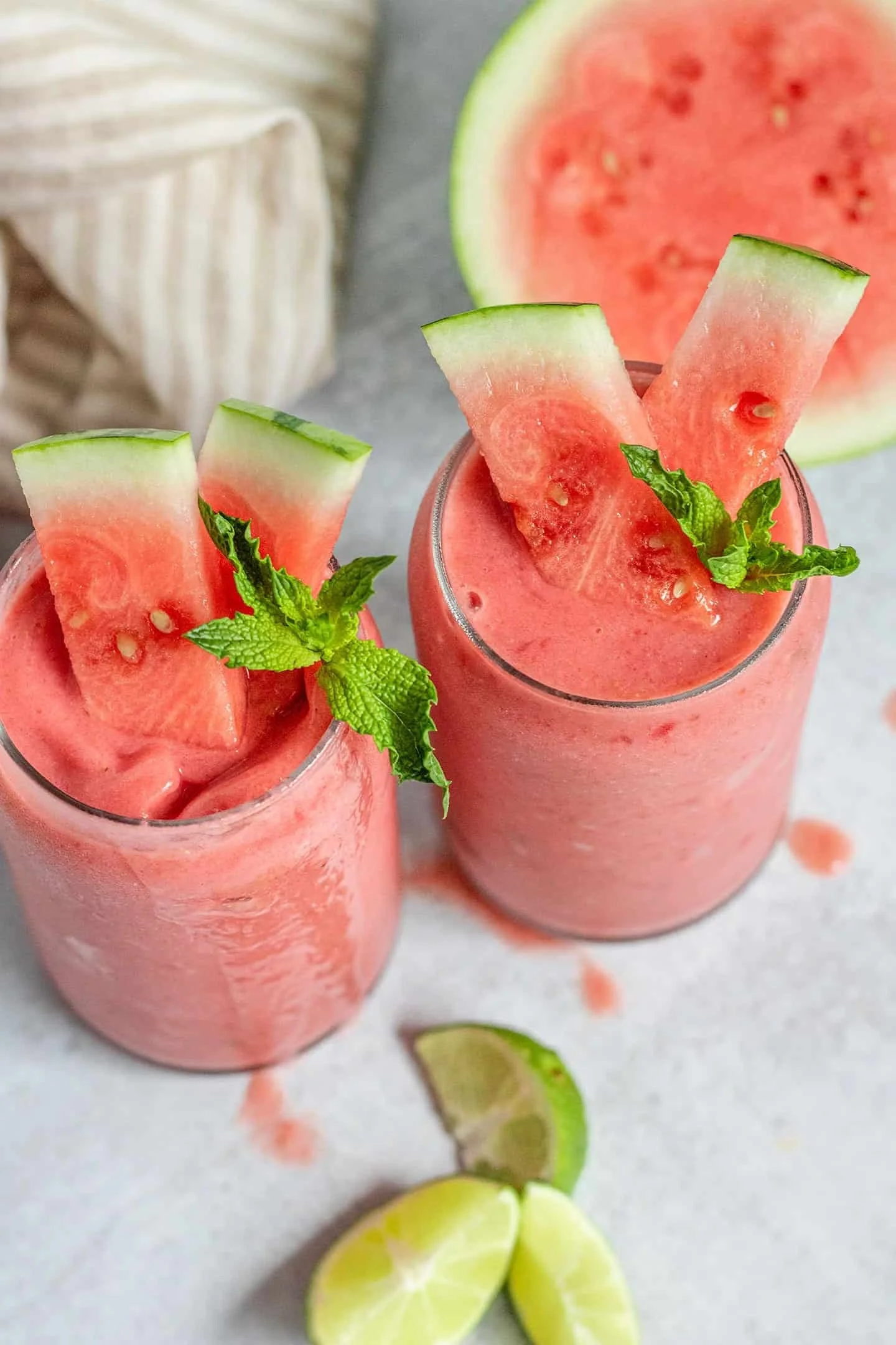 Refreshing watermelon smoothie in a glass topped with mint leaves