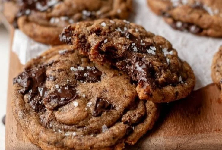 Espresso Infused Chocolate Chip Cookies on a plate, topped with coffee beans