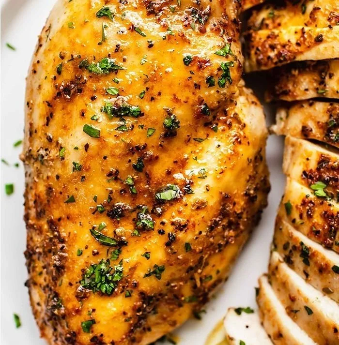 Healthy juicy air fryer chicken served with vegetables on a plate.
