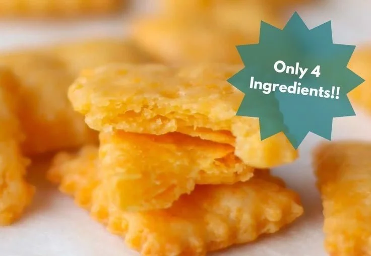 Freshly baked homemade cheese crackers on a wooden board