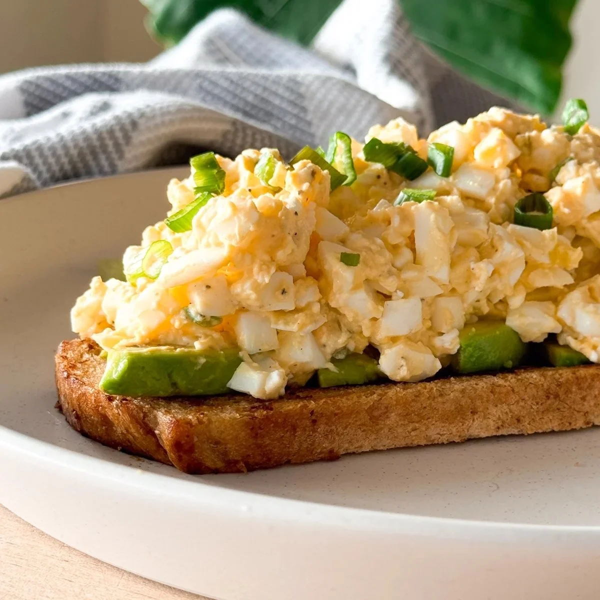 Mayo-free cottage cheese egg salad in a bowl, garnished with herbs