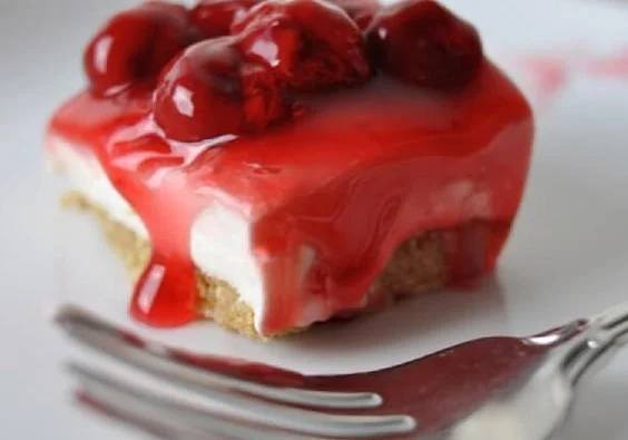 No-bake cherry cheesecake topped with fresh cherries and whipped cream