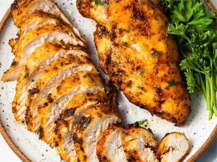 No-breading air fryer chicken breast served on a plate with fresh herbs