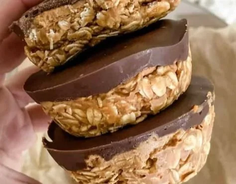 Oat cups filled with creamy peanut butter, a healthy snack option.