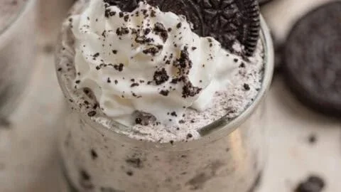 Oreo no-bake cheesecake cups topped with crushed Oreos.