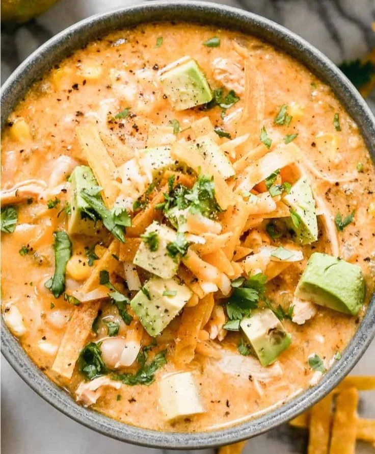 Delicious protein-rich white chicken chili served in a bowl with toppings.