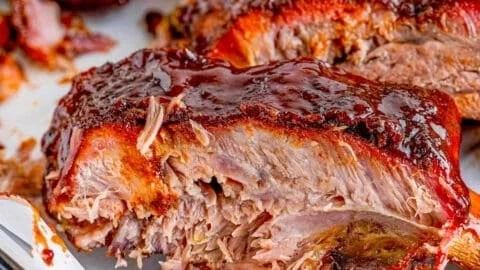 Delicious smoked ribs ready for serving on a wooden platter