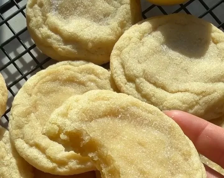 Plate of soft and chewy lemon cookies with a bright yellow hue