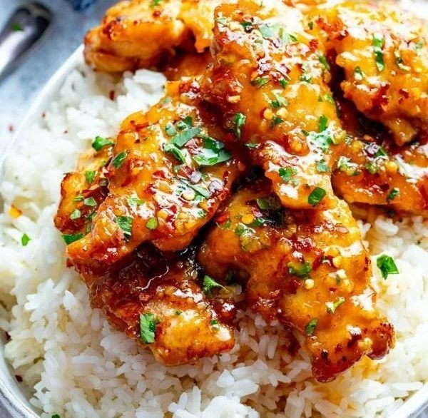 Sticky honey garlic chicken thighs served with vegetables