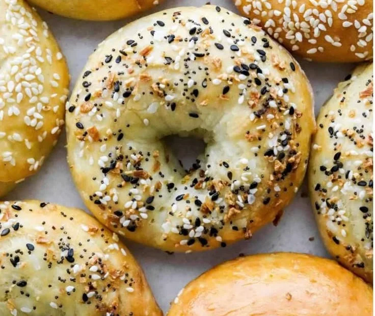 Golden brown air fryer bagels freshly made and served on a wooden board.