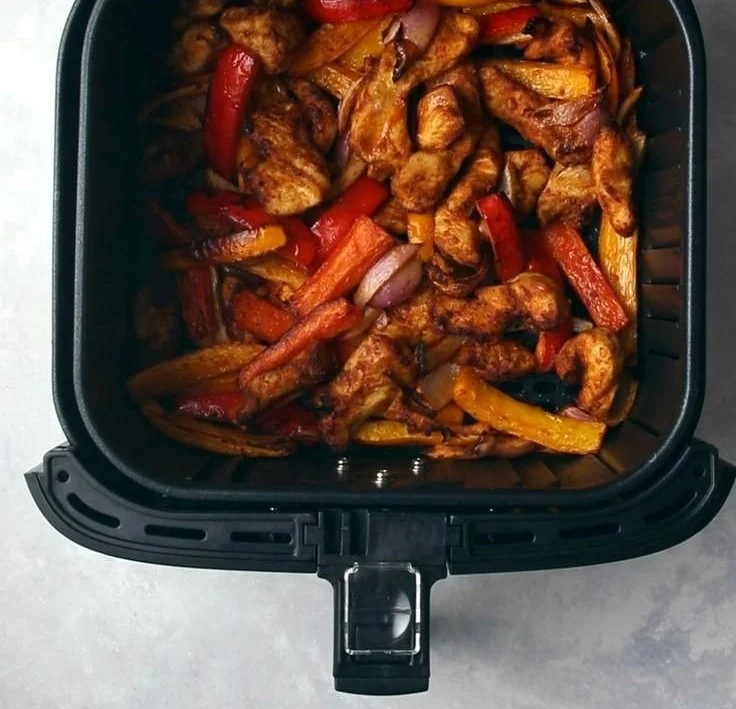 Delicious Air Fryer Chicken Fajitas served with peppers and onions.