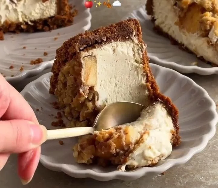Delicious slice of Apple Crumble Cheesecake topped with crumbles and apple slices