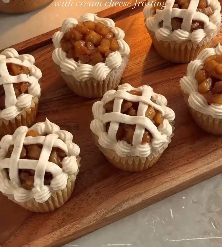 Delicious apple pie cupcakes topped with frosting and cinnamon